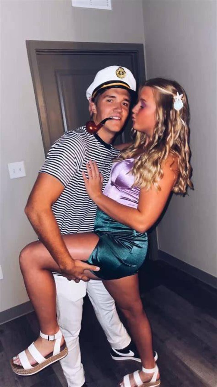 A couple of college girls were seen representing their sororities and some fraternities by writing Greek letters on their body with marker