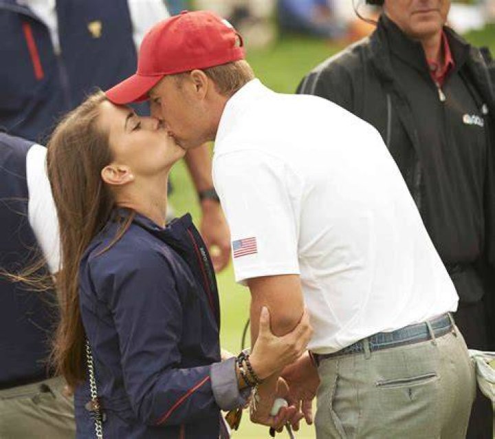 Annie Verret kissing Jordan Spieth after winning the golf tournament