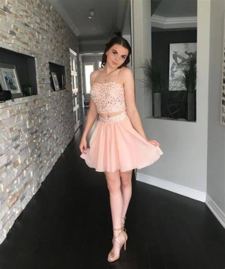 Avery Trask poses a picture in a black top.