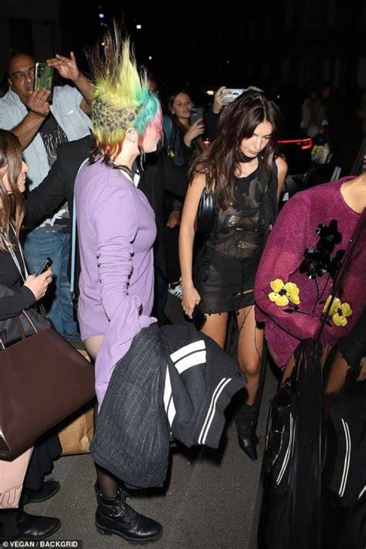 Bizarre: During the show, Cara Delevingne also appeared in the crowds as a punk (she is pictured at the afterparty still sporting the same quirky hairstyle she debuted on stage)