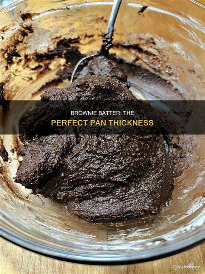 Brownie batter in a pan topped with peanut butter