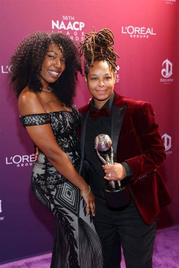 Chaunte Wayans in black coat and white top in her wallpaper to the latest show.