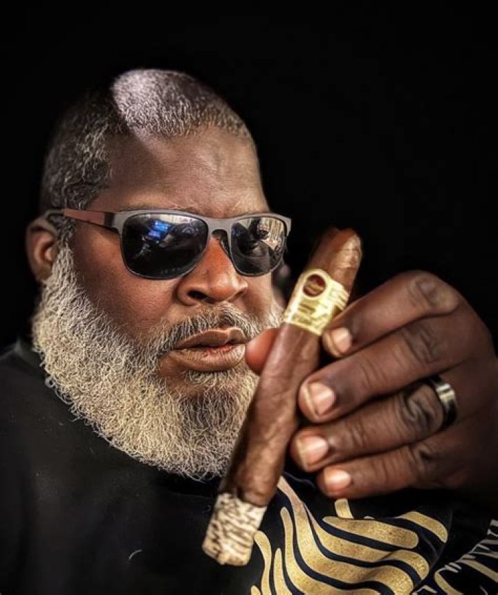 Cigar: Looking relaxed and happy as he manoeuvred his classic eggshell vehicle, the erstwhile Mr. Universe and Mr. Olympia enjoyed a cigar during his outing