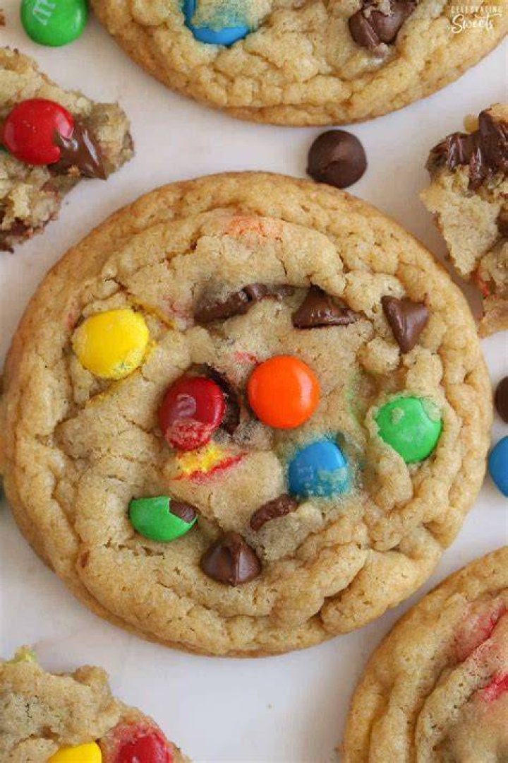 Closeup of cookies topped with pastel M&M's and sprinkles.