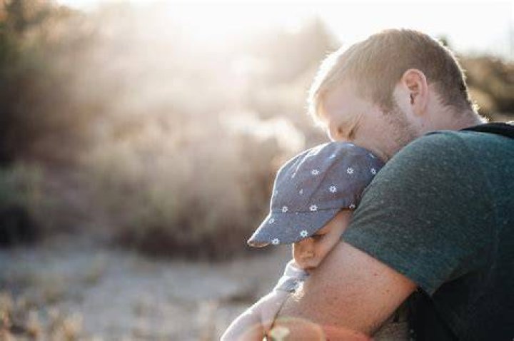 Daddy's little girl: Eric planted a kiss on his daughter's cheek