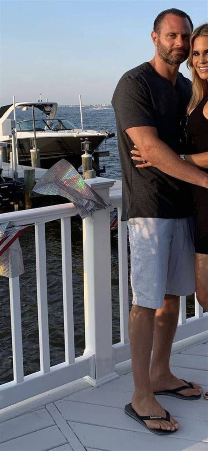 Evan Goldschneider in a grey t-shirt poses alongside her beau Jackie Goldschneider.