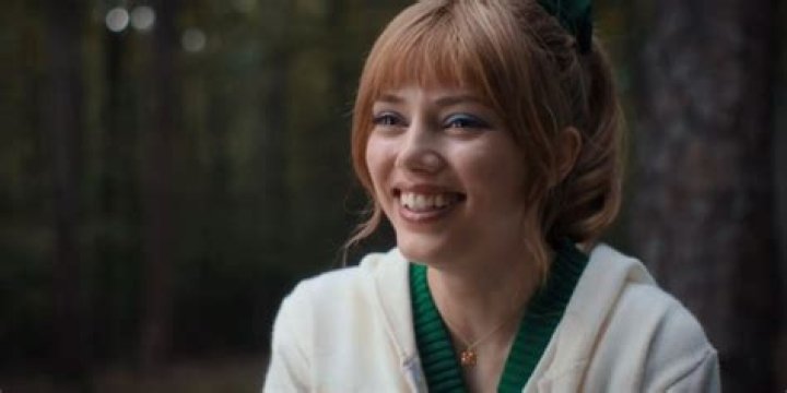 Grace Van Dien as Chrissy in 'Stranger Things' Season 4. Chrissy wears a cheerleading outfit and waves pom poms.