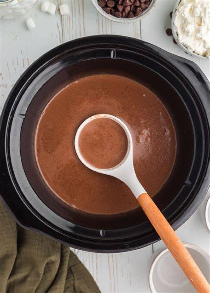 Hot chocolate in a crock pot topped with marshmallows.