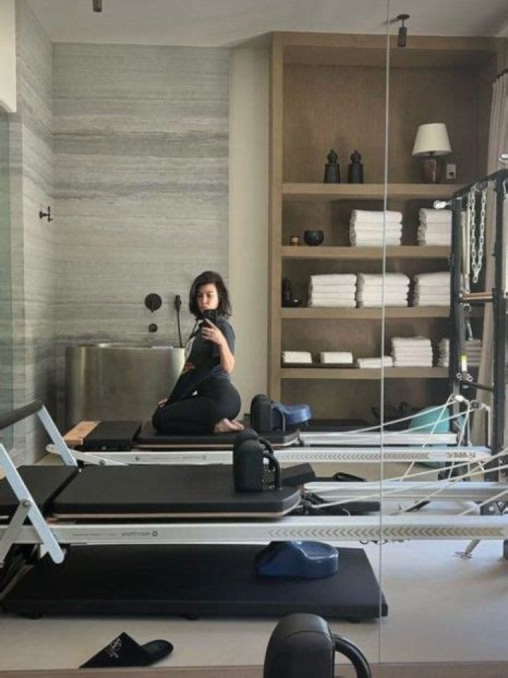 Kourtney covers up in a baggy top in a new photo amid rumors she's pregnant