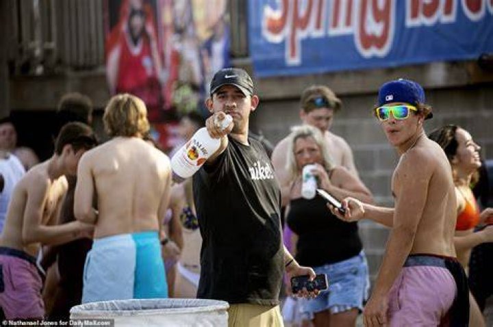 Partygoers were seen basking in the sun and knocking back drinks as they welcomed Governor Greg Abbott\'s reopening of the state