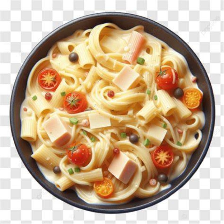 Pasta in a bowl topped with chicken.