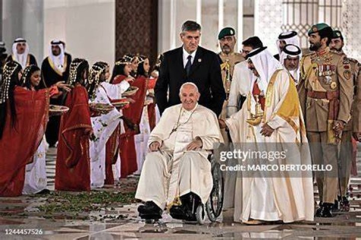 Pope Francis is escorted by his bodyguards as he arrives in the popemobile car to St Peter's Square on April 20