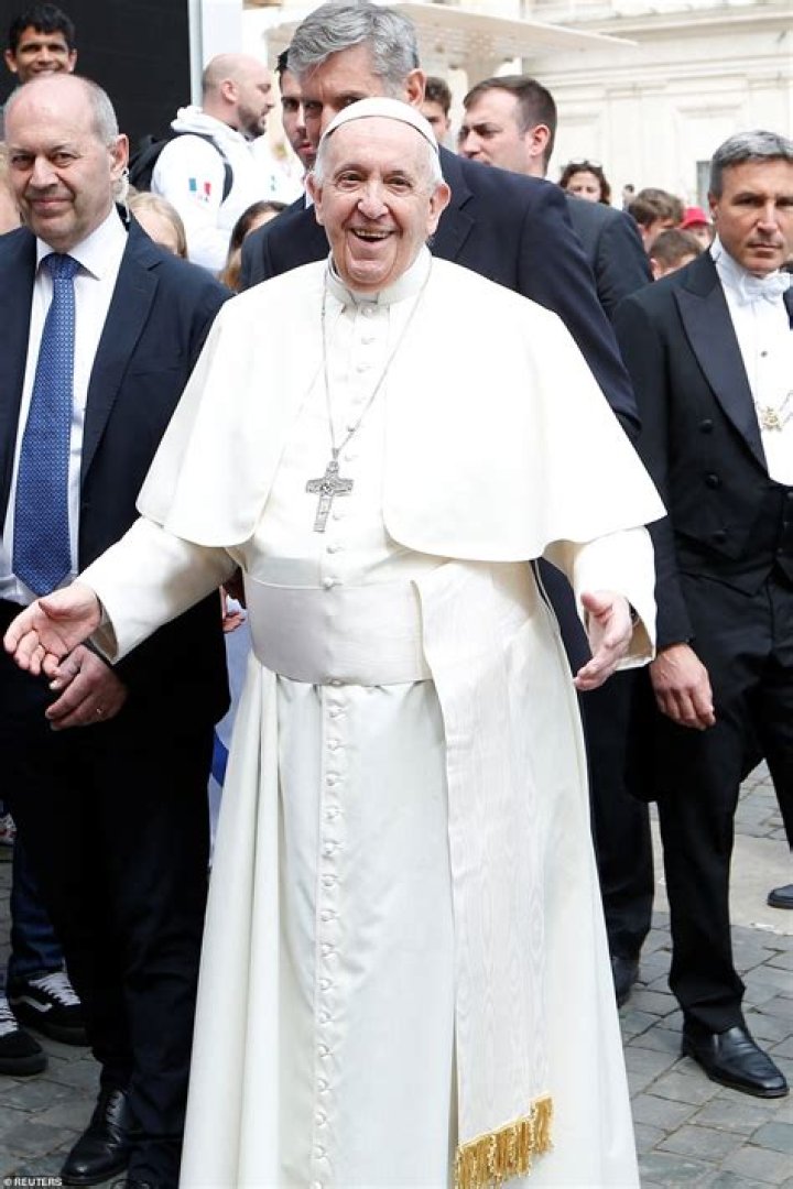 Pope Francis smiled and opened his arms wide in an embrace at the end of the general audience