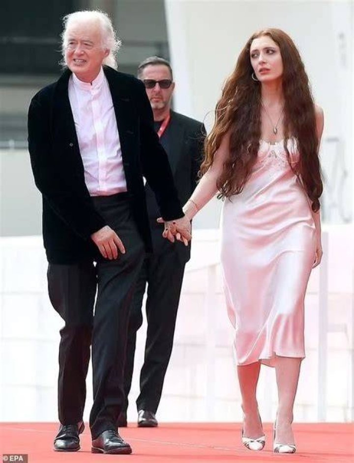 Scarlett Sabet wearing a pink silk gown and Jimmy Page in a tuxedo at the red carpets.