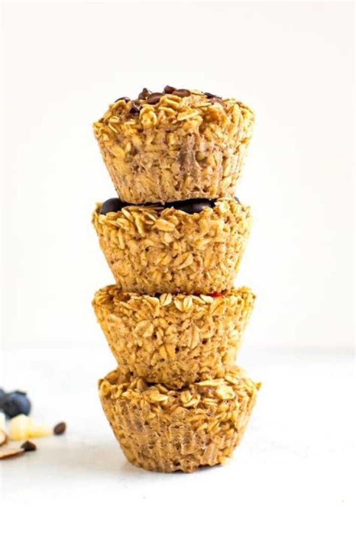 Stack of baked oatmeal cups with chocolate and raisins. 