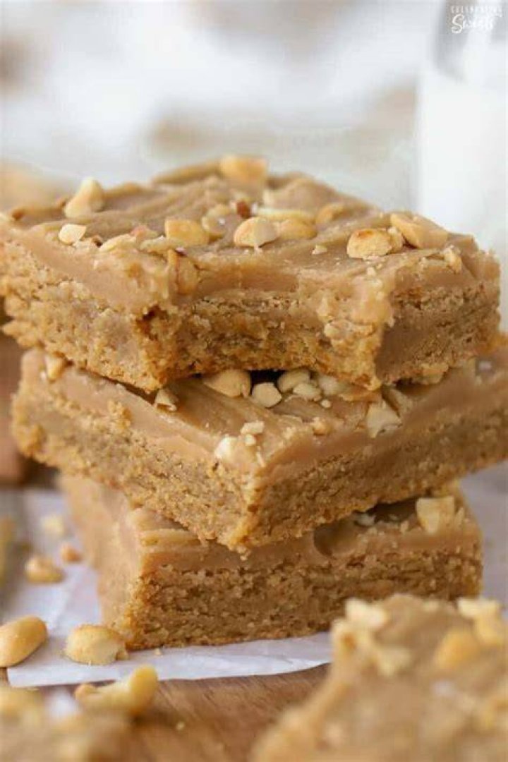 Stack of three peanut butter brownies on parchment paper
