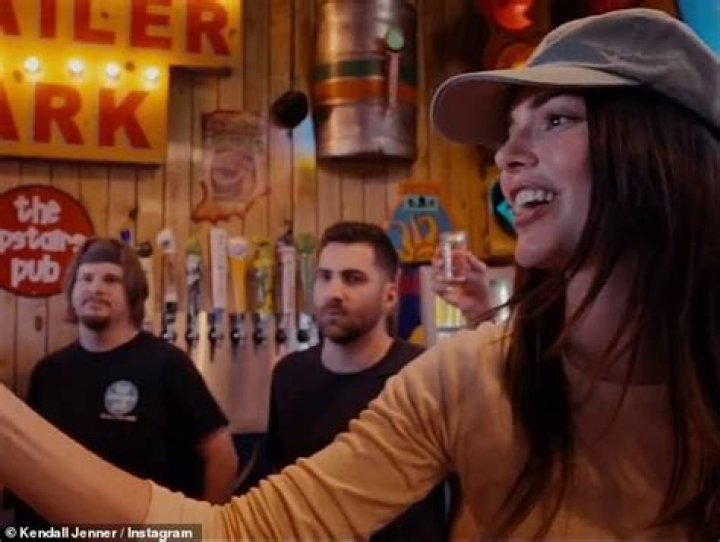 Tending bar: She stood behind the bar to greet hoards of students who gathered to meet her and take shots with her