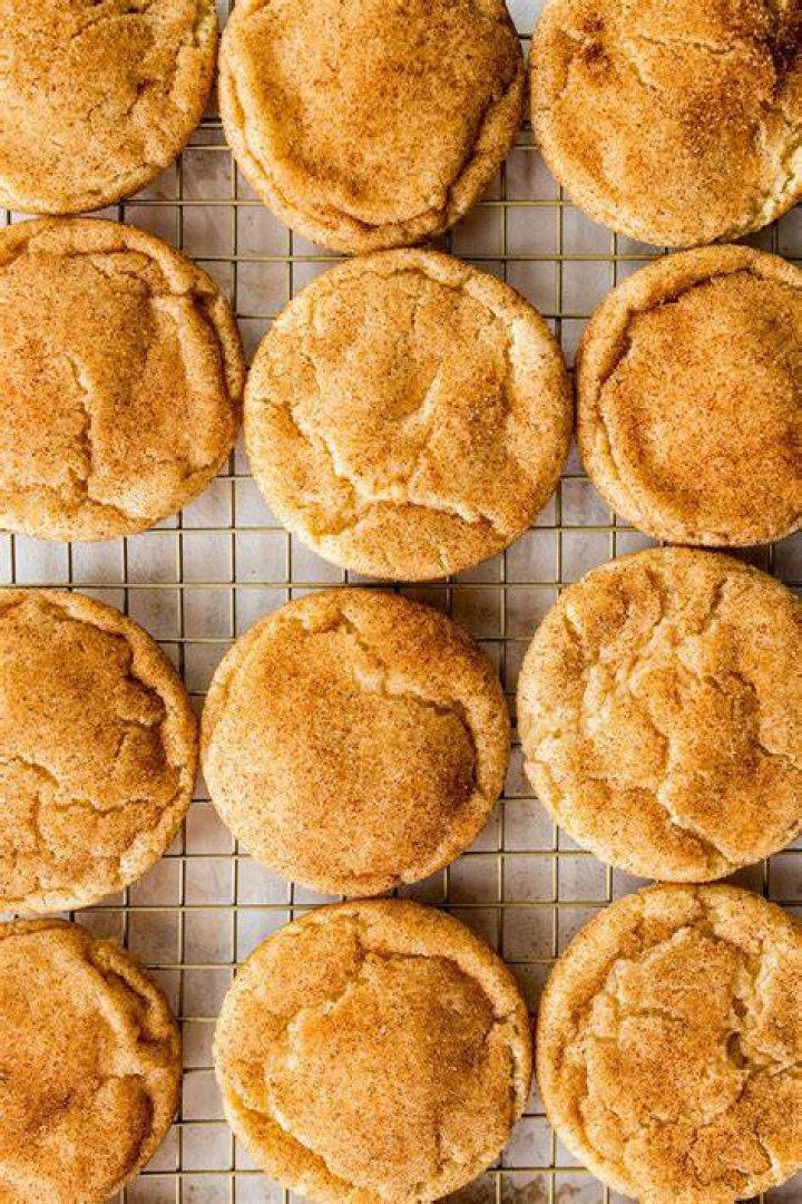 Two halves of maple snickerdoodle cookies stacked on top of each other.